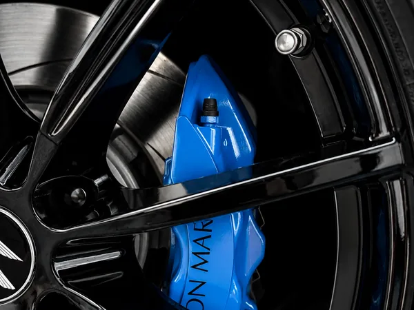 Blue painted brake caliper behind gloss black wheel — Hussle Customz Los Angeles