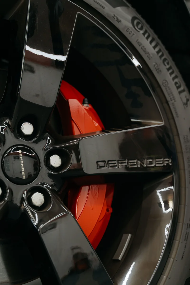 Red painted brake caliper on gloss black wheel — Hussle Customz Los Angeles