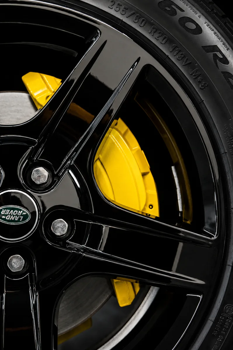 Yellow painted brake caliper on gloss black wheel — Hussle Customz Los Angeles