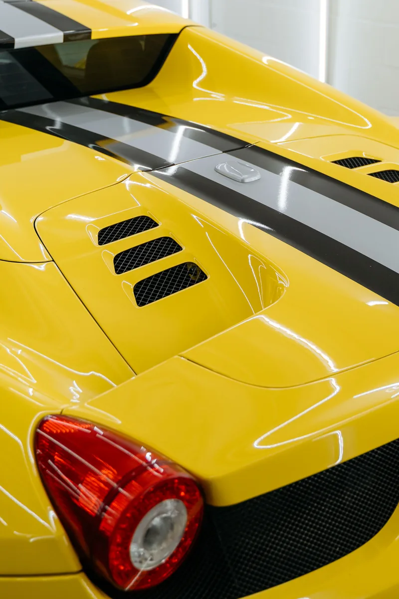 Black and grey Le Mans racing stripes on yellow Ferrari 458 Spider — rear deck view, Hussle Customz Los Angeles
