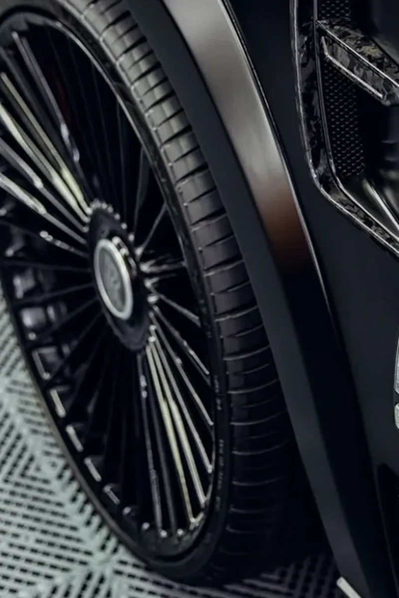 Close-up of gloss black powder-coated multi-spoke wheel on a satin black Rolls-Royce Cullinan widebody — Hussle Customz Los Angeles