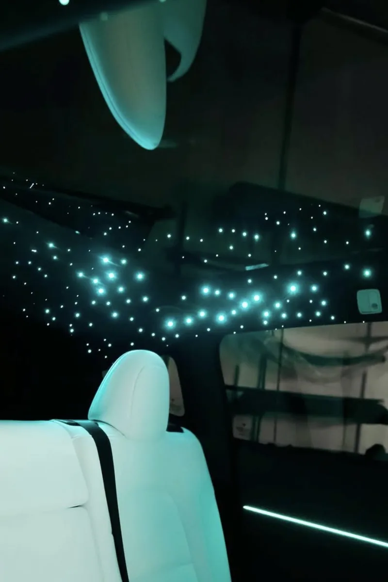 Close-up of fiber-optic starlight headliner stars in vehicle ceiling — Hussle Customz Los Angeles