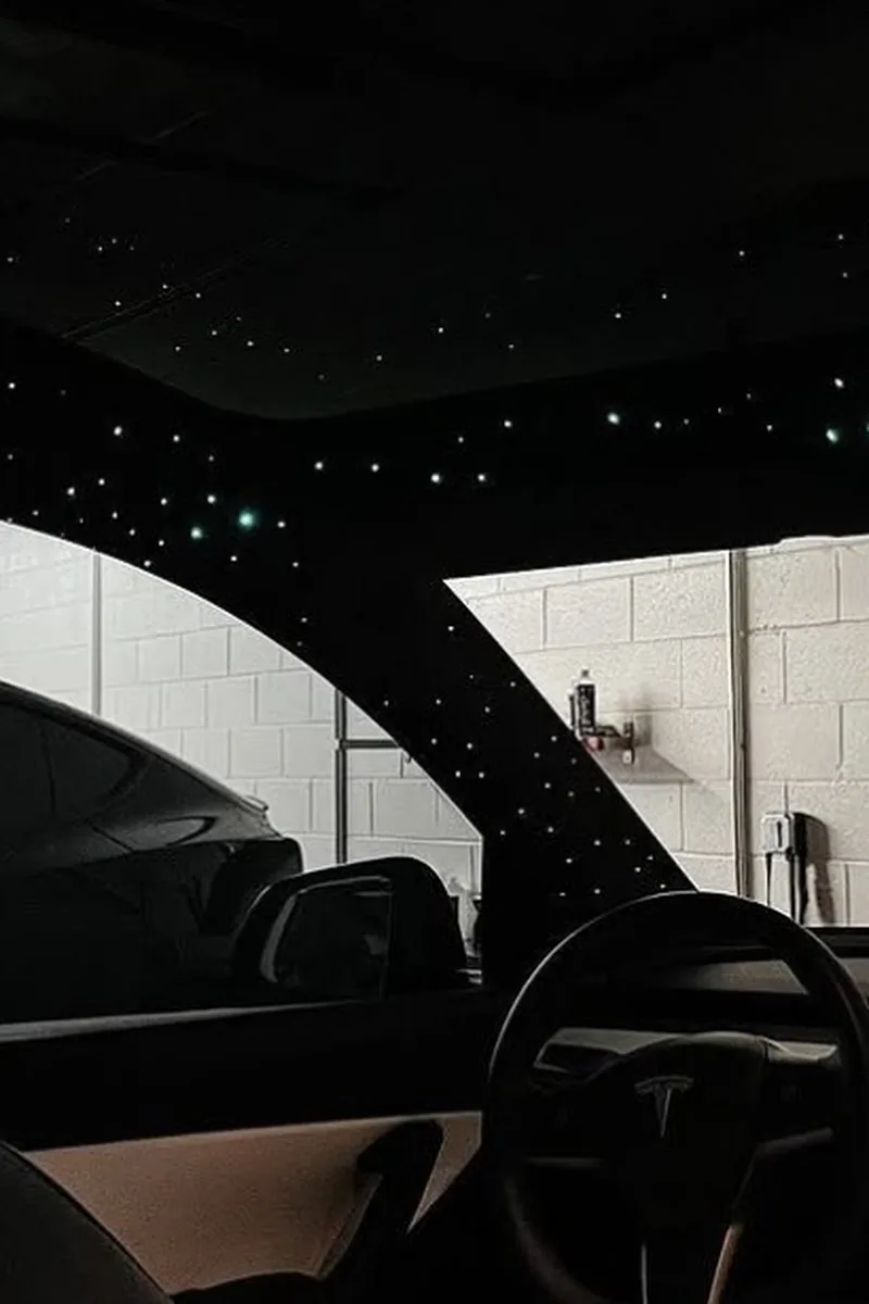 Tesla Model Y interior with custom fiber-optic starlight headliner and ambient lighting — Hussle Customz Los Angeles